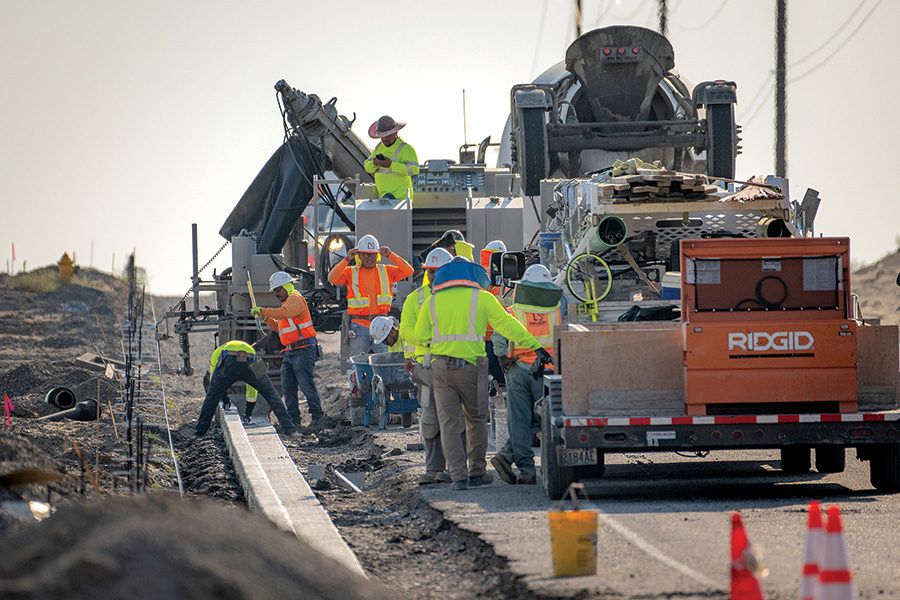 Road crews install concrete curbing along Burns Road adjacent to a new west Pasco development near the intersection of Broadmoor Boulevar in this file photo.