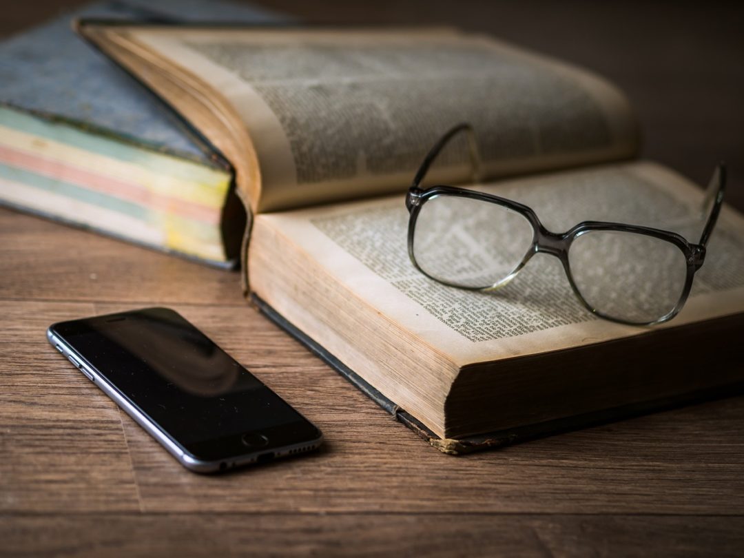 Books and glasses and phone