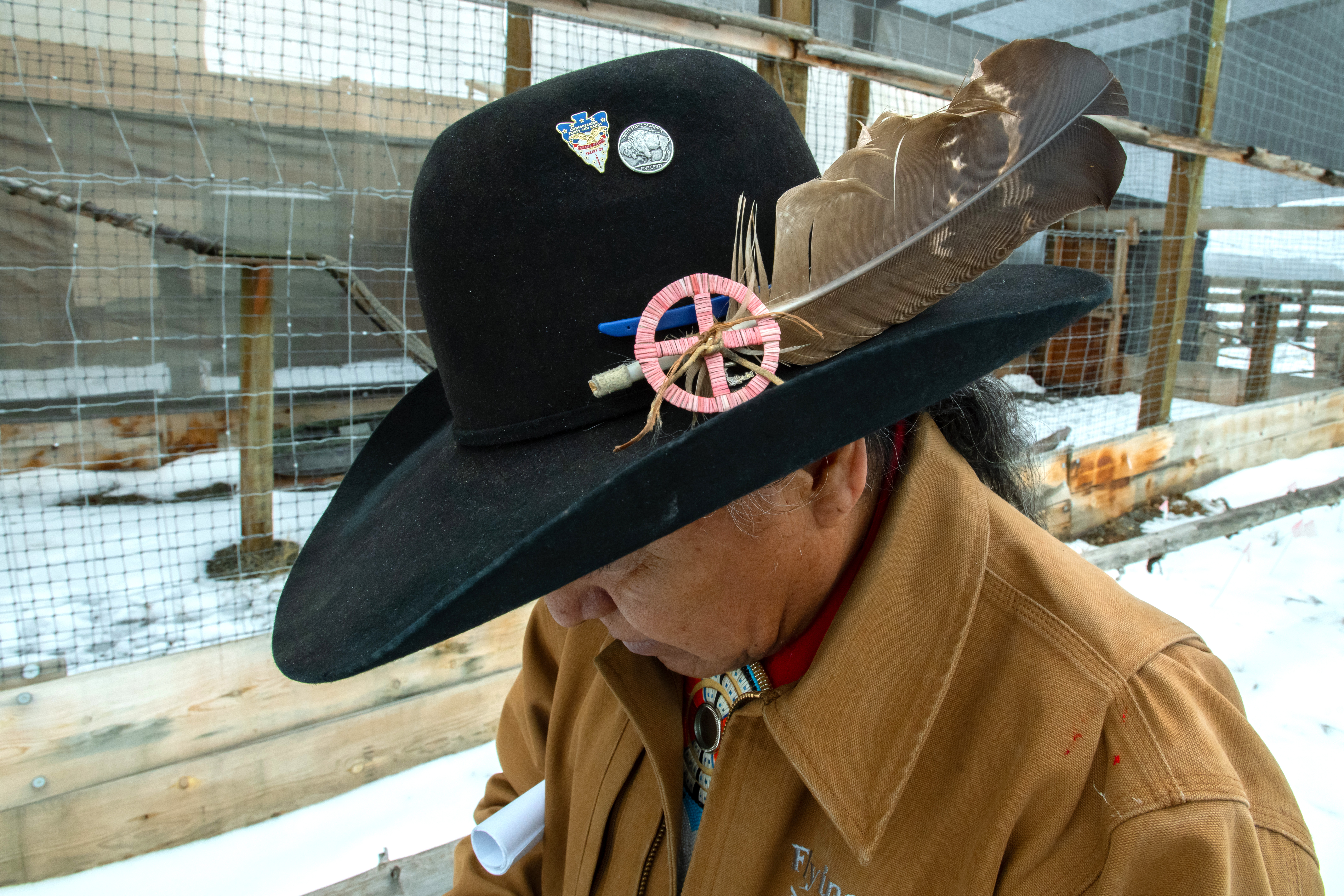 Eagle feather in Yakima Nation member's hat.