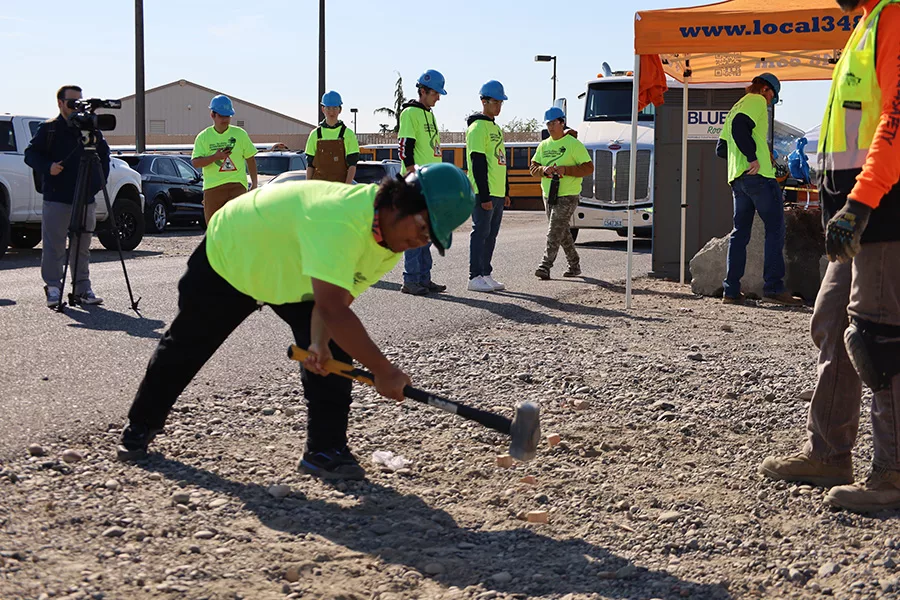 Student with sledge hammer