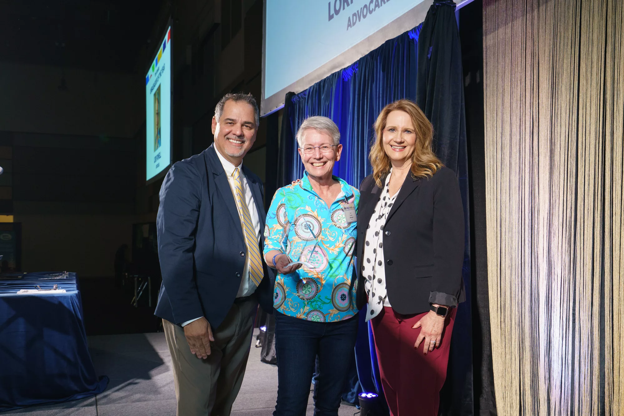 Photo of Tom Powers Ambassador of the Year Award winner Lori Powell with Thomas Drozt, Ben Franklin Transit and Lori Mattson, Tri-City Regional Chamber