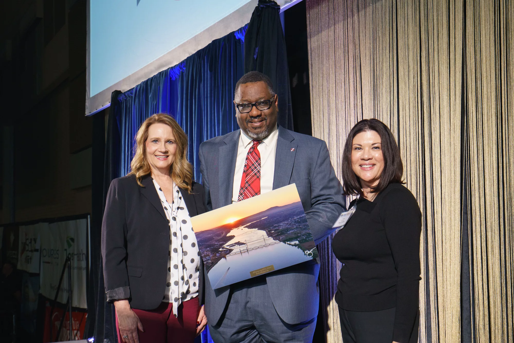 Photo of Corporate Impact Award winner Brian Hartman, Bechtel with Lori Mattson, Tri-City Regional Chamber and Emilia Keener, Lourdes Health & Trios Health