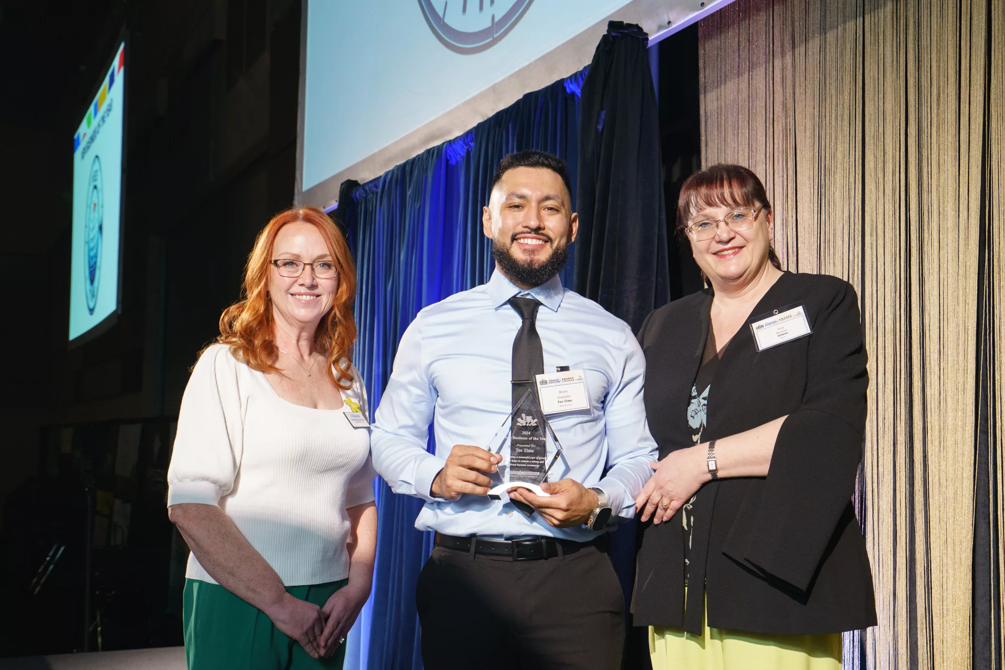 Photo of New Business of the Year award winner Reyes Gonzales of Tee Time with Christine Rose-Vanwormer and Amy Basche, Tri-City Regional Chamber