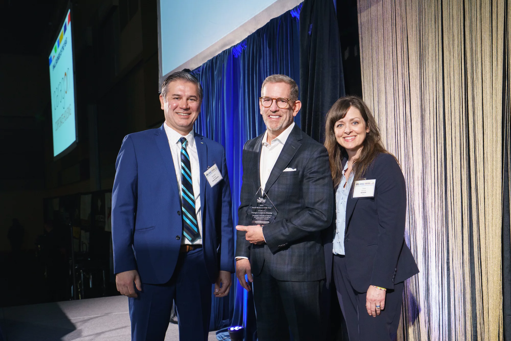 Photo of Small Business of the Year winner John Crook of Paragon Corporate Housing with Khurshed Sharifov, Charles Schwab and Trish Herron, Tri-City Regional Chamber
