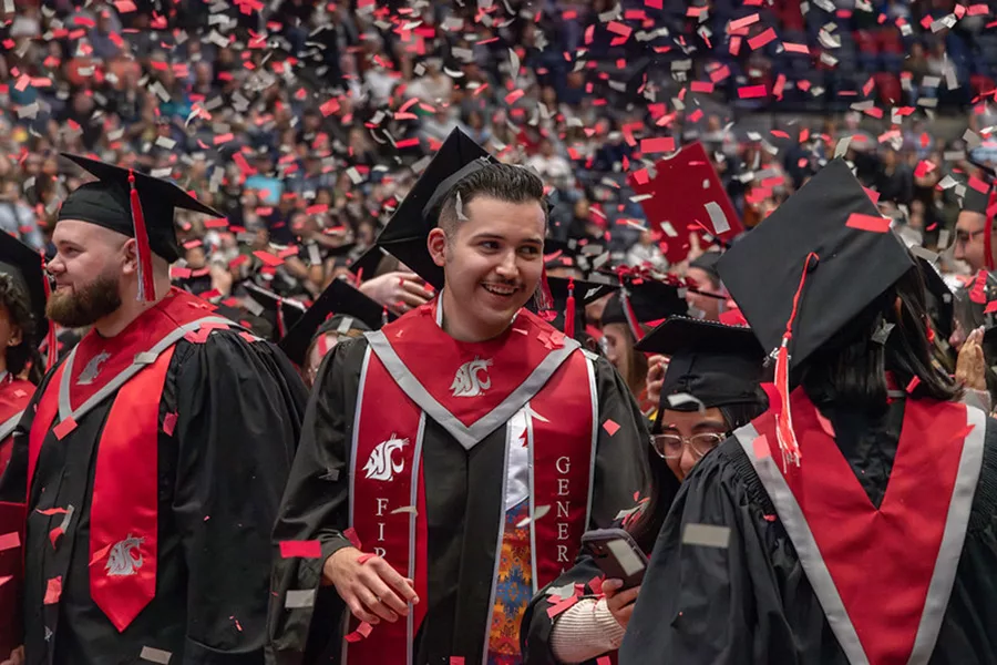 Students at WSU graduation with confetti.