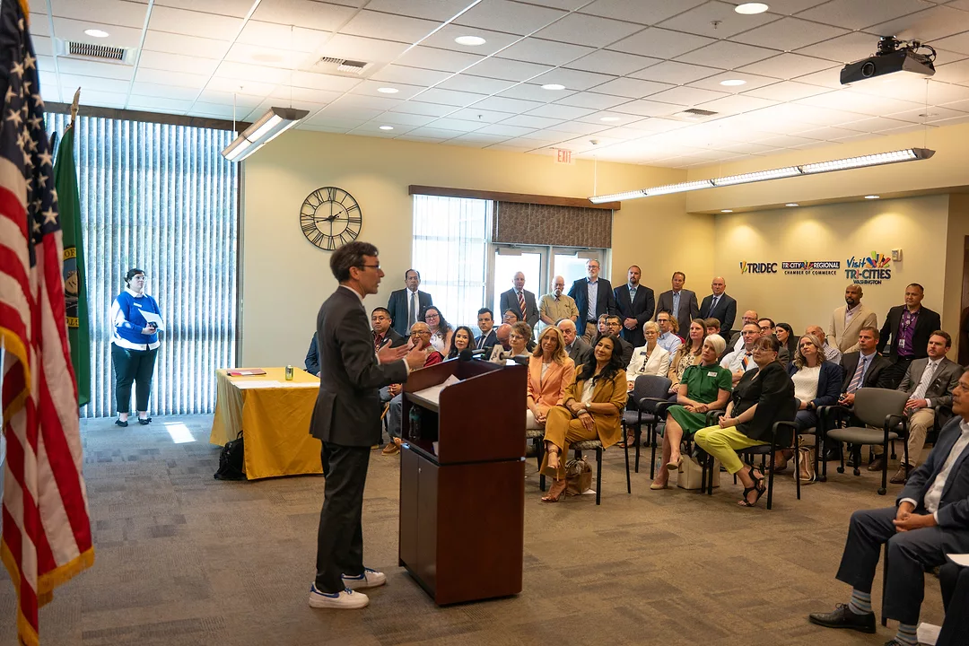 Gov. Bob Ferguson at podium in Kennewick during bill signing ceremony.
