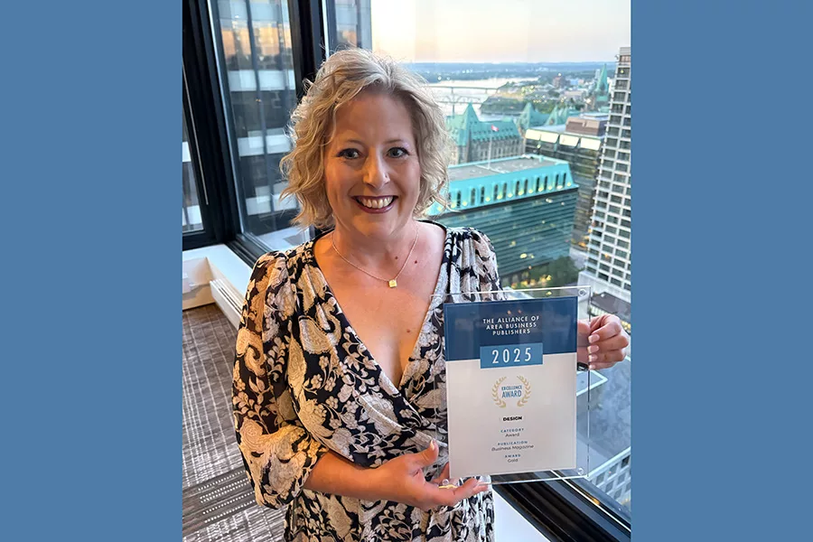 Tiffany Lundstrom holding an award.