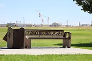 Port of Pasco bench sign with cranes in background.