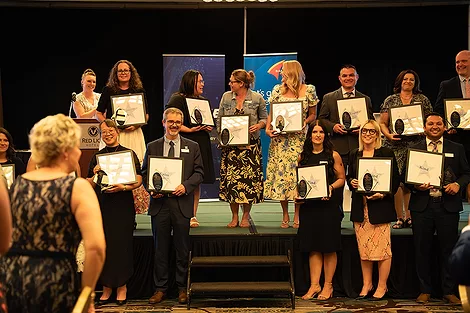 People standing with certificates.