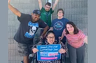 People posing with a sign that says, "Thank You for Supporting The Columbia Ability Alliance Giving Blitz 2025 Blitz Presented by H2C"
