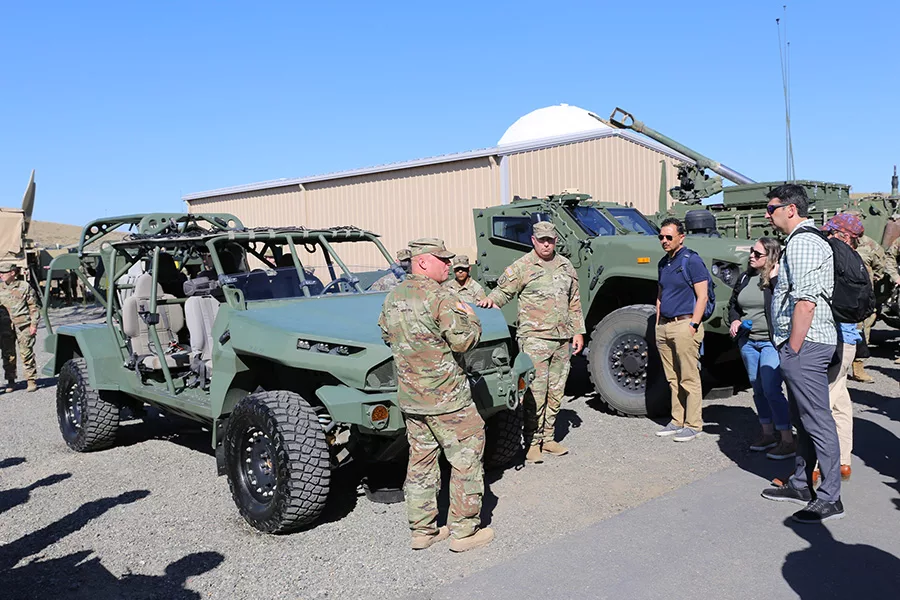 Service members and armored vehicles.