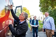 Man signing a bus.