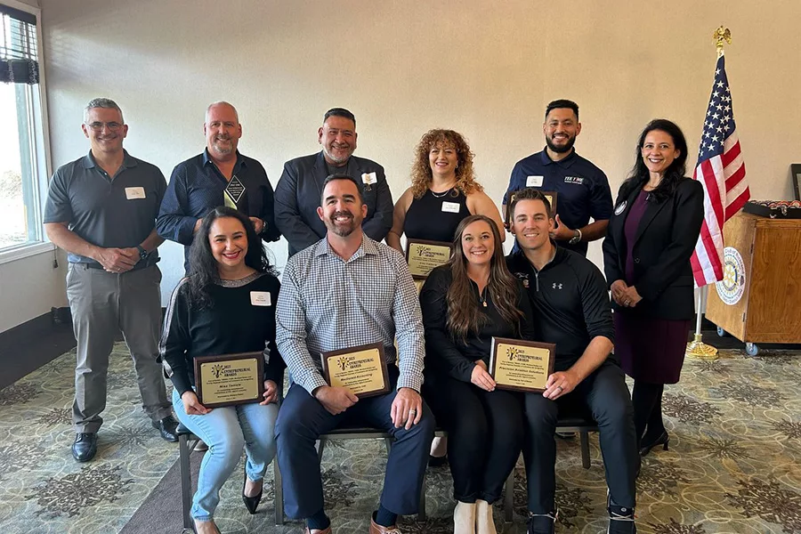 People posing with awards.
