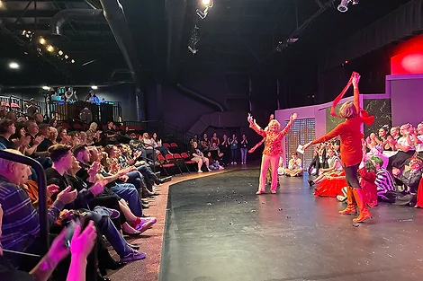 People performing on a stage with an audiance.