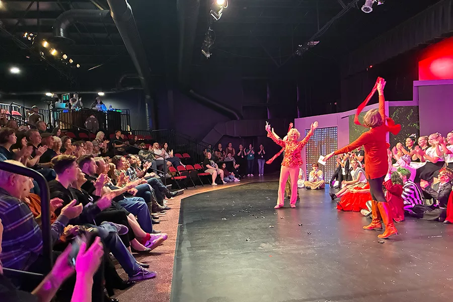 People performing on a stage with an audiance.