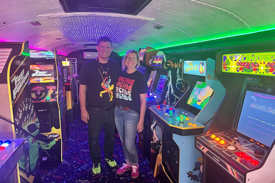 People standing inside an arcade.