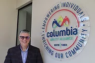 Man stands near sign that says, "Columbia Ability Alliance".