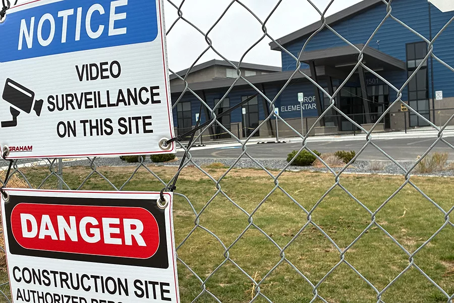 School behind a chain link fence.