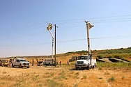 Work trucks near power lines.