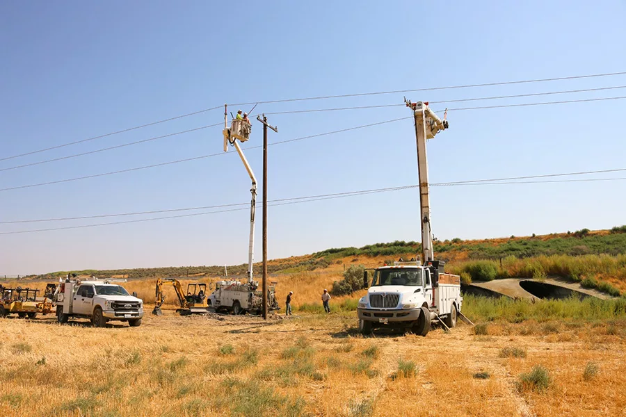 Work trucks near power lines.