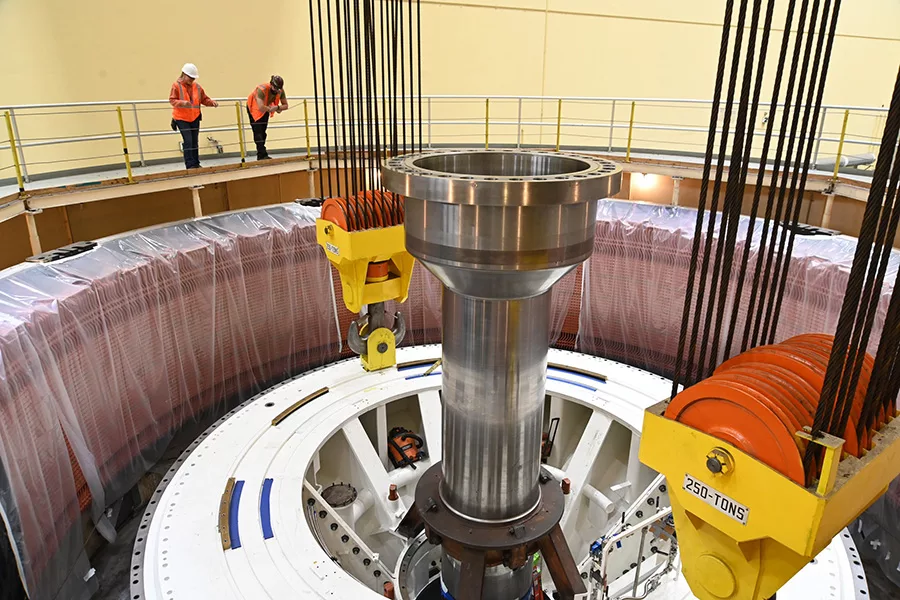 Workers looking over a railing.