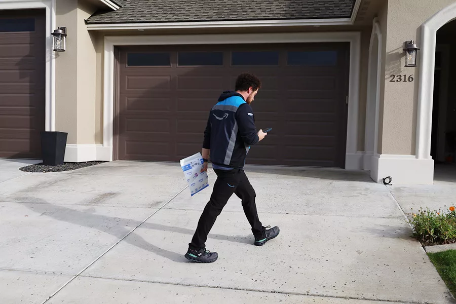 Amazon worker delivering a package.