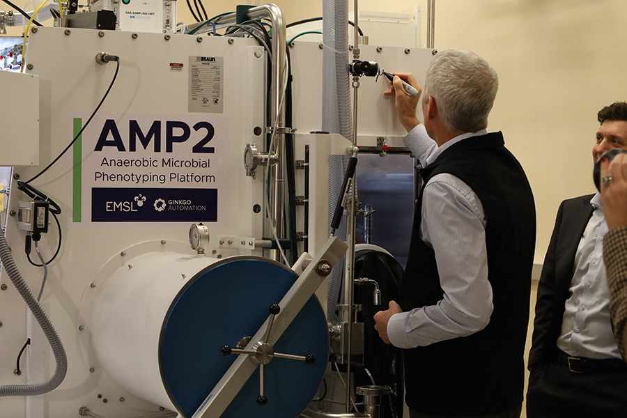 Person signing a machine.