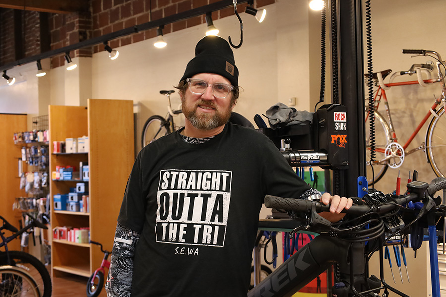 A man standing in a bike shop.
