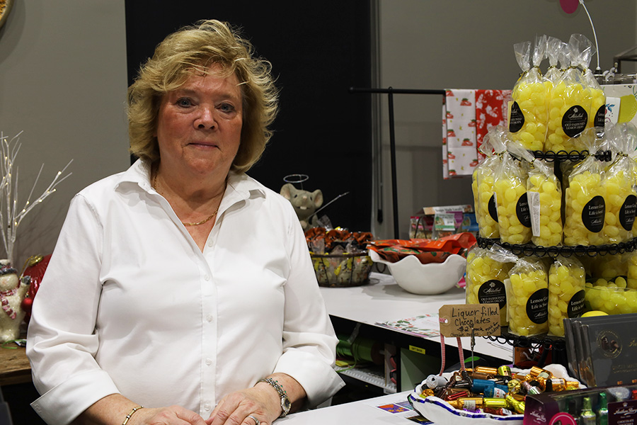 A woman sitting behind a counter.