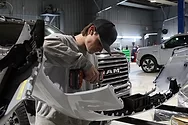 Person working on a car part.