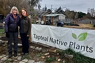 Two people near a "Tapteal Native Plants" sign.
