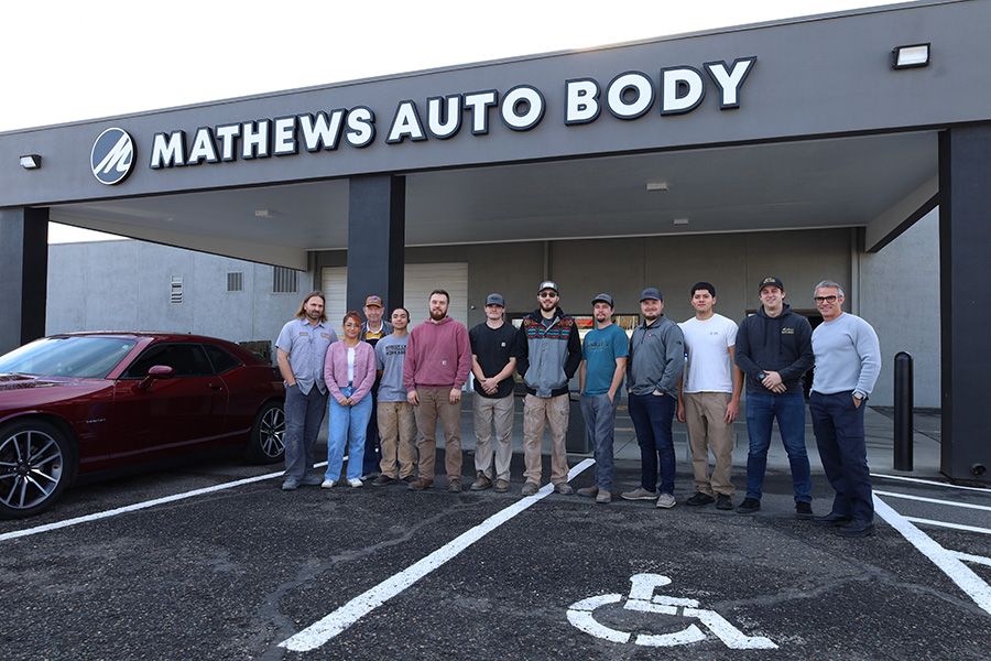 A team of people outside of Mathews Auto Body.