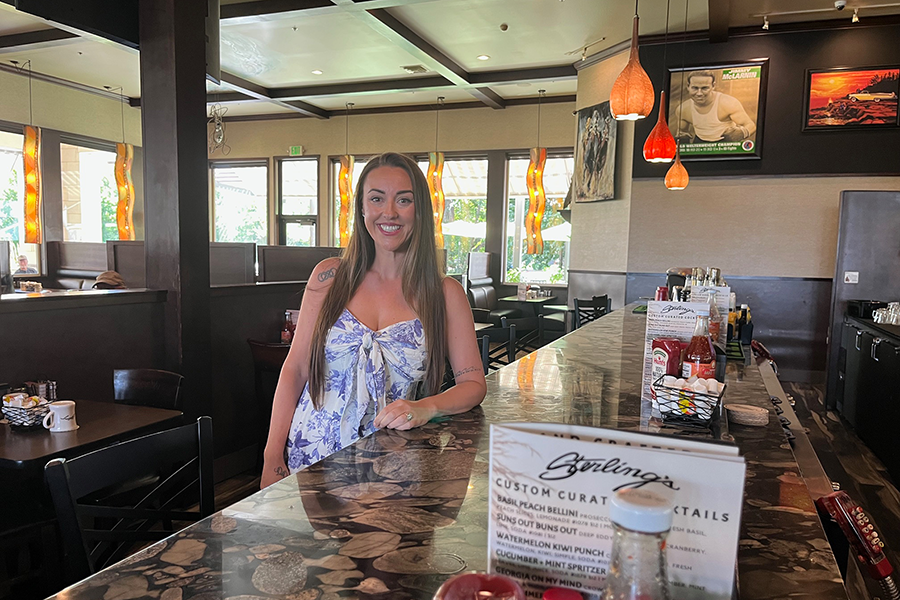 A woman leaning against a bar at Sterlings on Clearwater.