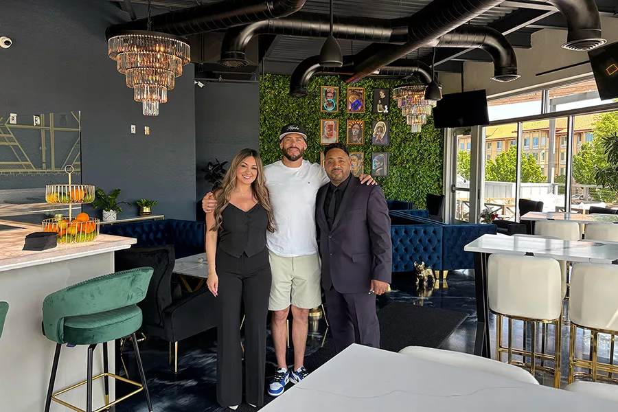 Owners standing inside the establishment.