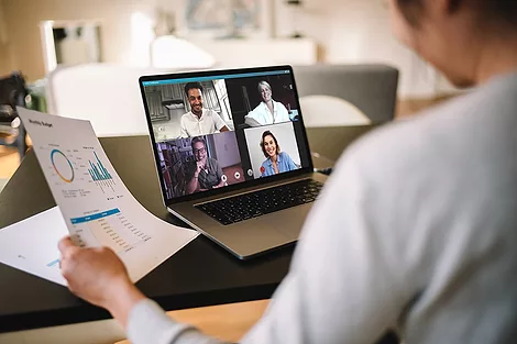 Person video calling on a laptop.