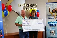 Two people holding a giant check.