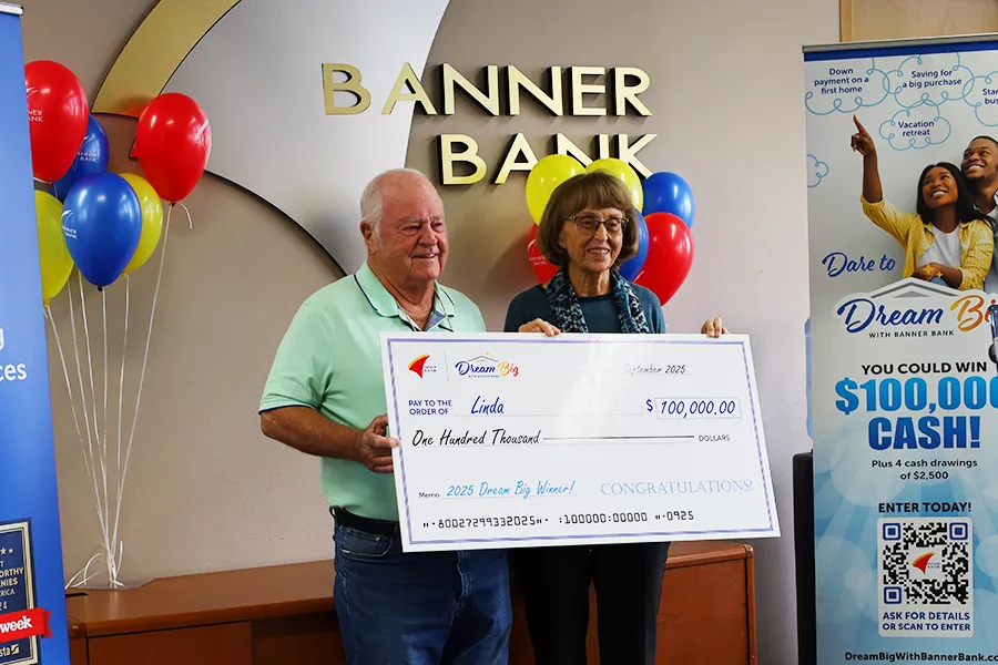 Two people holding a giant check.