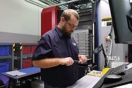 A man using manufacturing equipment.