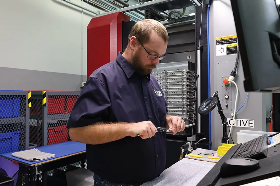 A man using manufacturing equipment.