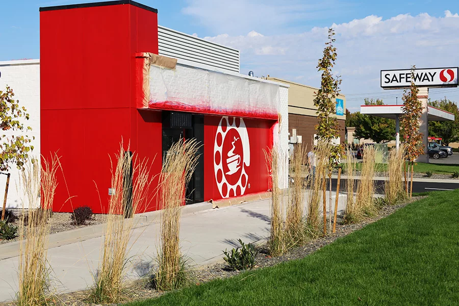 A Wake Up Call location under construction with a Safeway sign in the background.