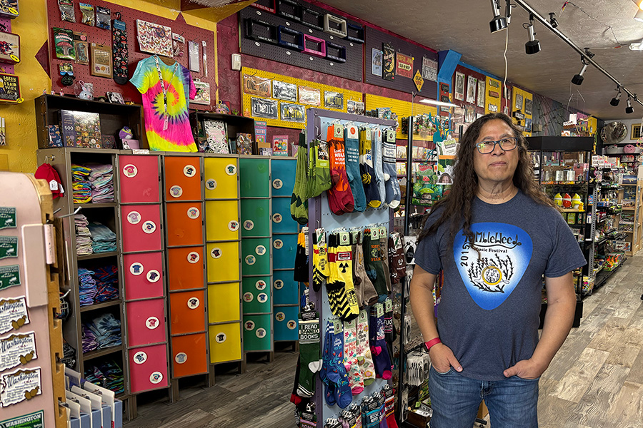 A person standing near a display of colorful socks.