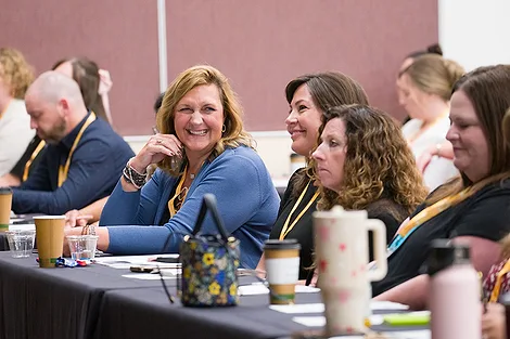 Women sitting behind tables.