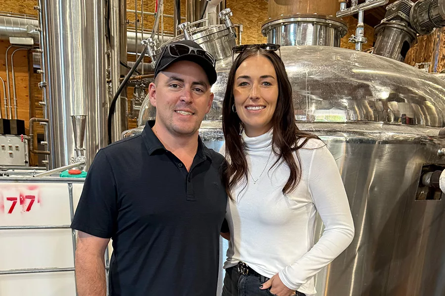 A couple near a distillery.