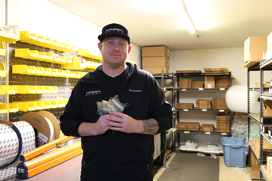 Man standing in a room of parts.