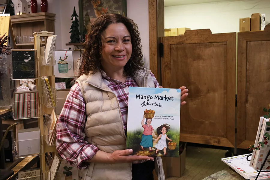 Woman holding a children's book.