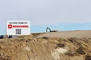 Rockwool sign with a digger in the background.
