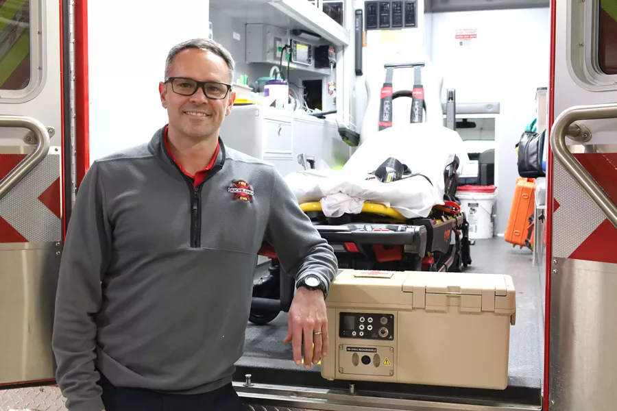 Man standing near an ambulance.