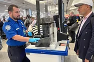 TSA agent at a counter.