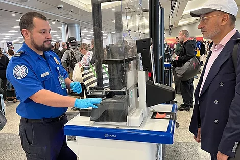 TSA agent at a counter.