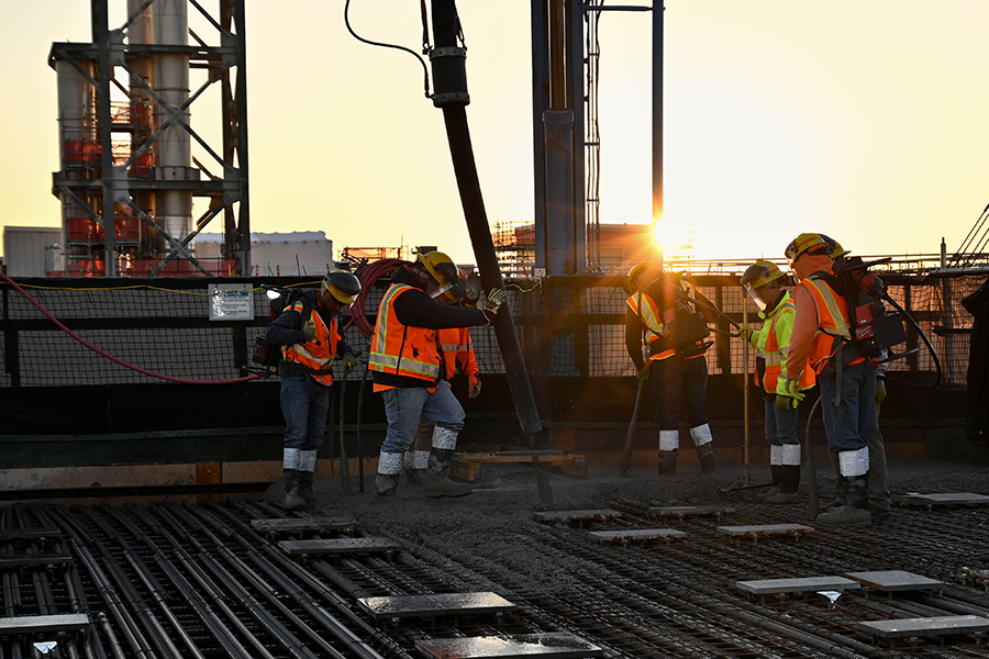 Workers pouring concrete.
